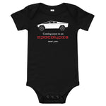 Tesla inspired apparel. Cybertruck. Apocalypse Near You image centered on baby onesie.