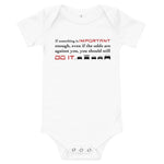 Tesla inspired apparel. Elon Musk quote. Against All Odds image centered on white onesie.