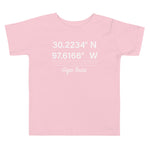 Tesla inspired apparel. Texas Gigafactory GPS coordinates. Birthplace Texas image centered on toddler t-shirt.